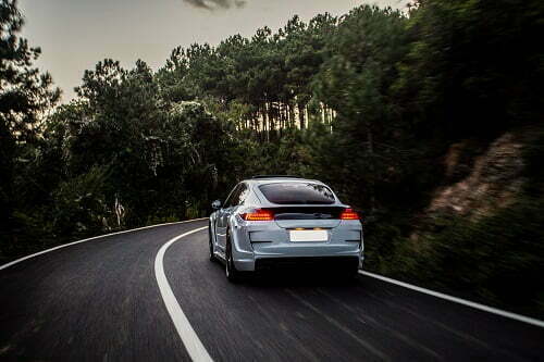sport-car-with-black-white-autotuning-driving-forest